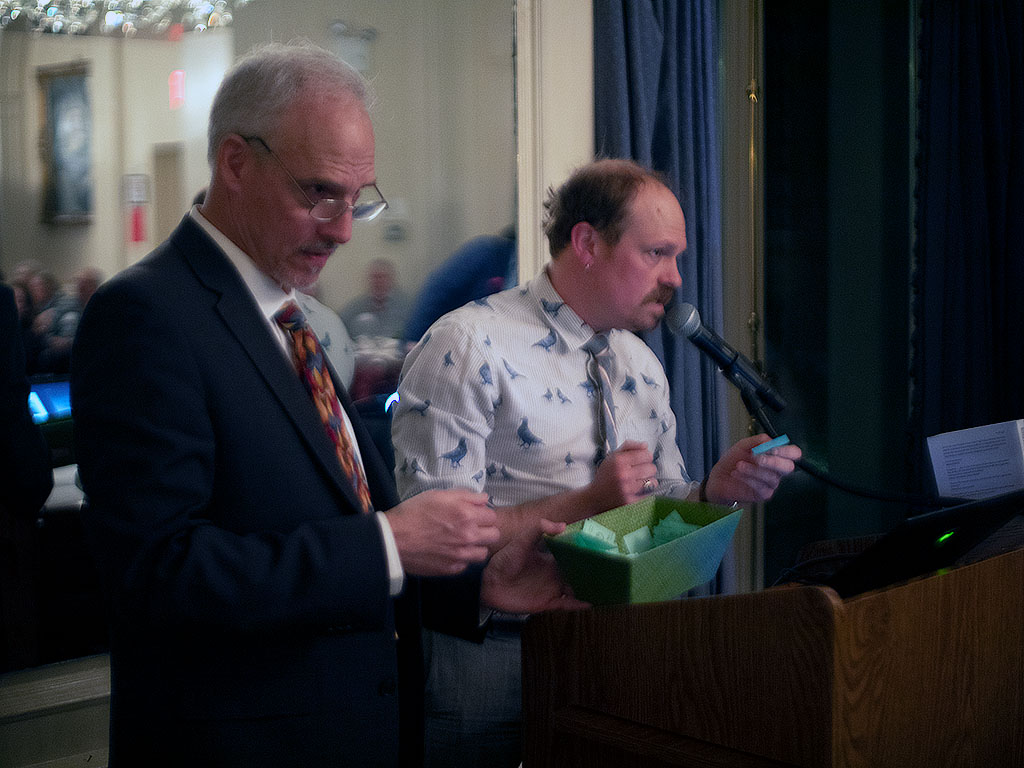 Council member Gabriel Willow assists with the raffle drawing