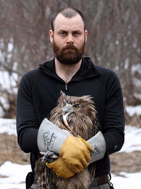Jonathan C. Slaght, Ph.D. holding Blakiston’s Fish Owl.