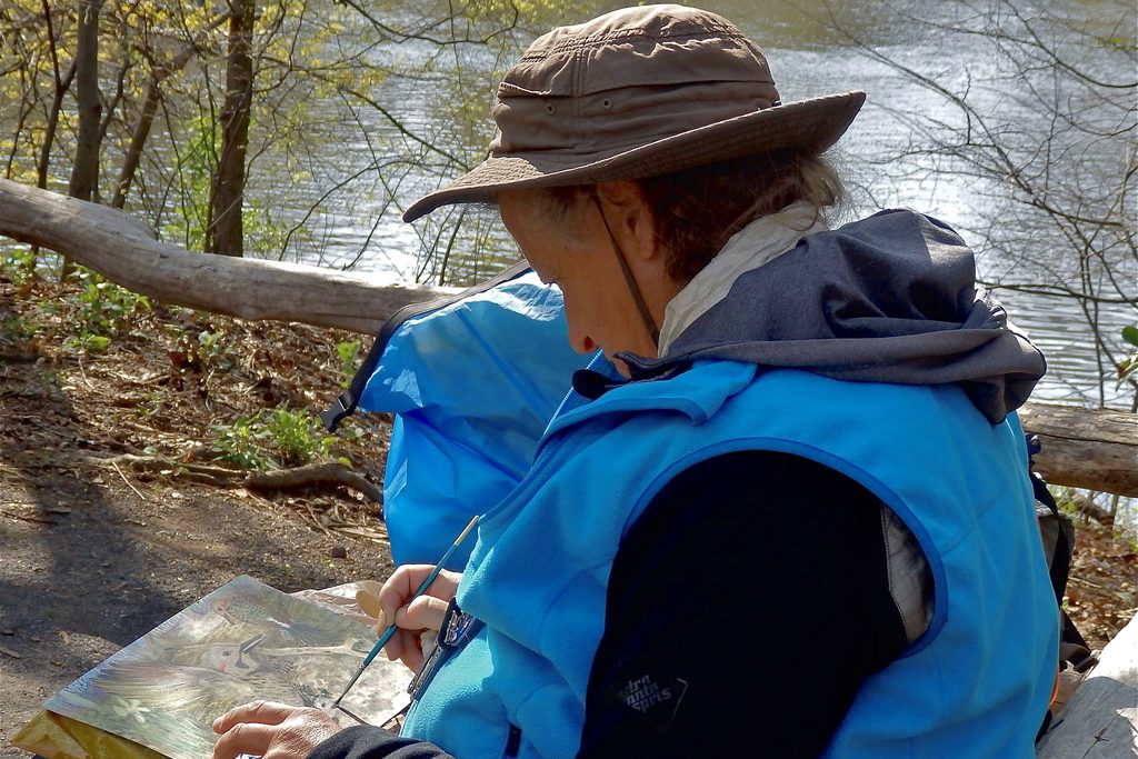 Lee sketching outdoors beside the water in Central Park