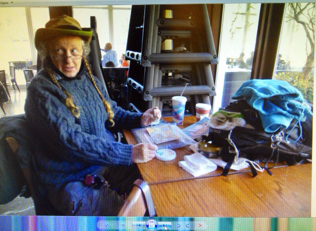 Lee Rogers painting at a table in the Central Park Boathouse café
